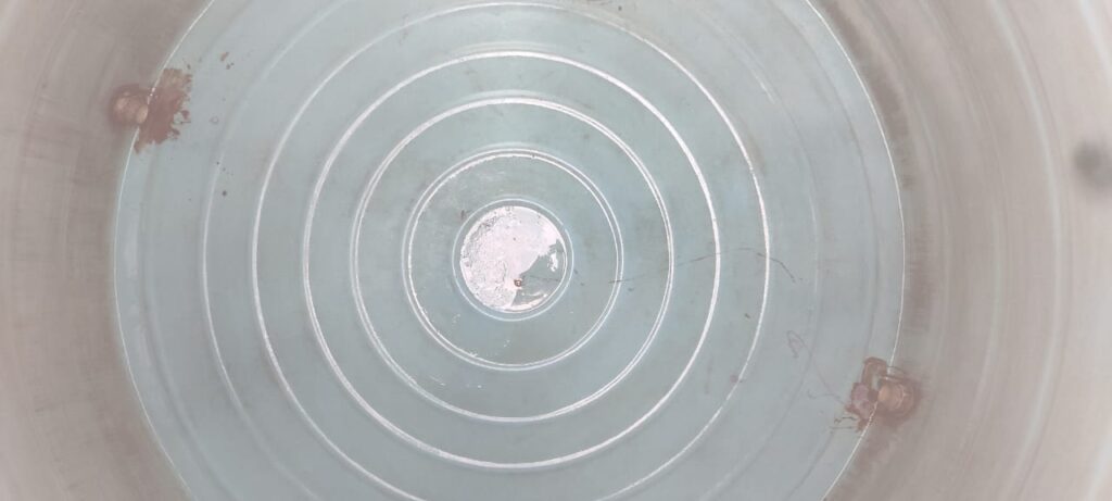 Technician cleaning algae from inside a plastic water tank in Chennai – safe water awareness."