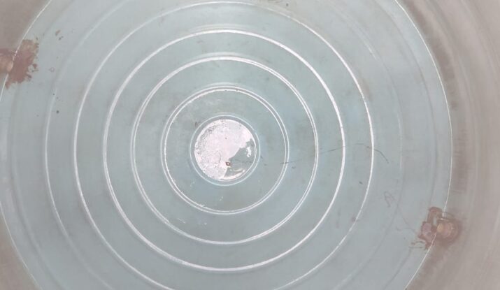 Technician cleaning algae from inside a plastic water tank in Chennai – safe water awareness."