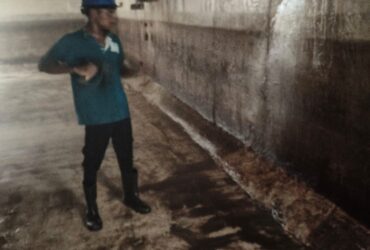 Professional Water tank cleaning service Adyar technician wearing PPE gear including gloves, boots, mask, and protective sui