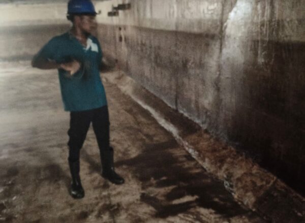 Professional Water tank cleaning service Adyar technician wearing PPE gear including gloves, boots, mask, and protective sui