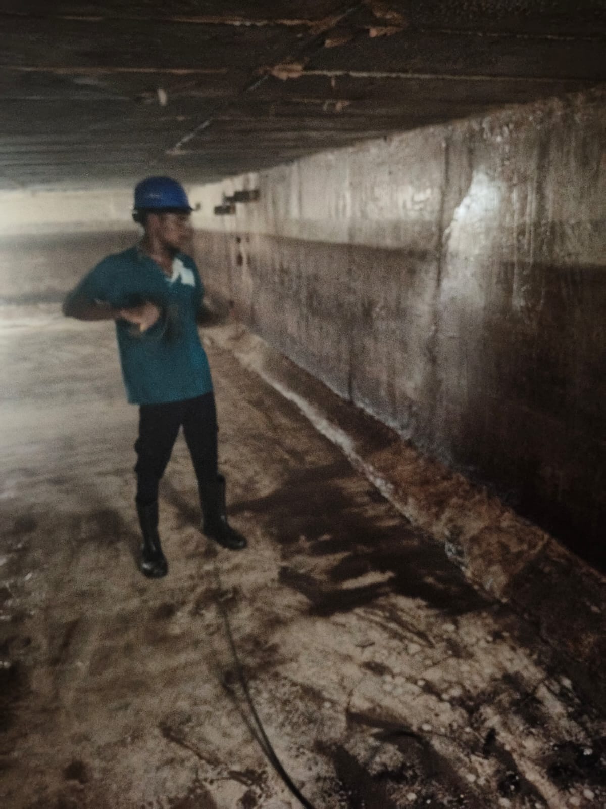 Professional Water tank cleaning service Adyar technician wearing PPE gear including gloves, boots, mask, and protective sui